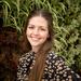 Ana Restrepo saenz  has long shoulder length hair wearing a floral top smiling directly at the camera.