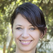 Jane Gingrich's headshot shows her with her hair tied up, smiling at the camera.