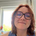 Woman with shoulder length hair and brown glasses