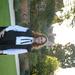 Matriculation Nicola is have brown/redish shoulder length hair, is wearing a graduation gown with glasses and smiling at the camera.