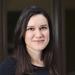 Dr Gabriela Pavarini has shoulder length dark hair, waring a black top smiling gently at the camera.