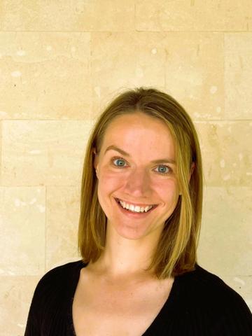 Susan Swingler has shoulder length blond hair and is smiling 
